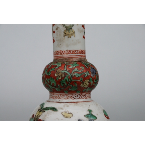 617 - A Chinese Kangxi famille rose triple gourd vase decorated with precious objects, 26cms high.