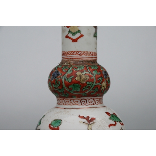 617 - A Chinese Kangxi famille rose triple gourd vase decorated with precious objects, 26cms high.