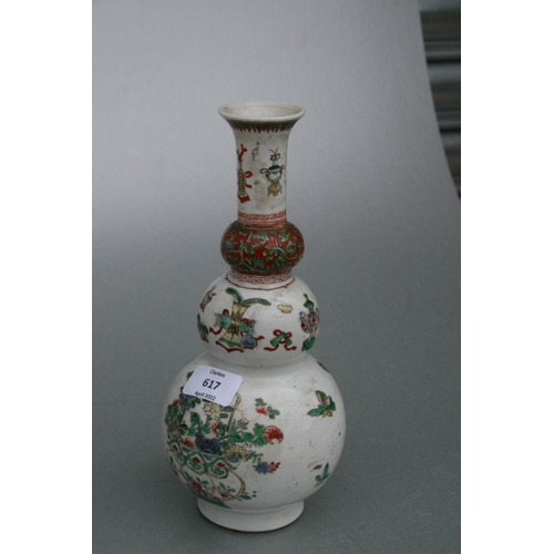 617 - A Chinese Kangxi famille rose triple gourd vase decorated with precious objects, 26cms high.