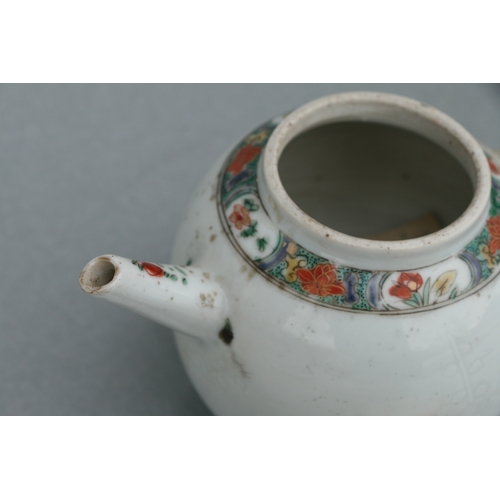 619 - A Chinese famille rose teapot of globular form, decorated with sgraffito and flowers, 11cms high.