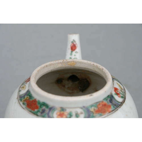 619 - A Chinese famille rose teapot of globular form, decorated with sgraffito and flowers, 11cms high.