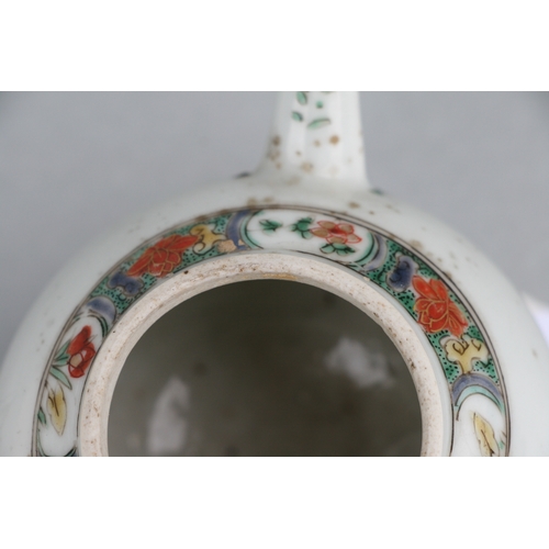 619 - A Chinese famille rose teapot of globular form, decorated with sgraffito and flowers, 11cms high.