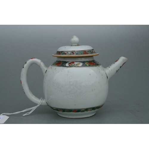 619 - A Chinese famille rose teapot of globular form, decorated with sgraffito and flowers, 11cms high.