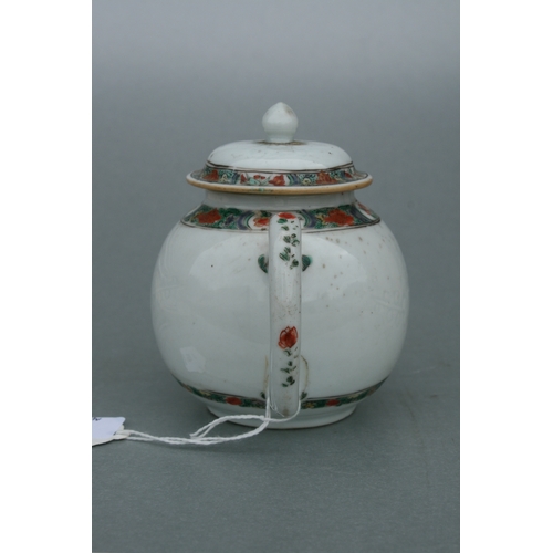 619 - A Chinese famille rose teapot of globular form, decorated with sgraffito and flowers, 11cms high.