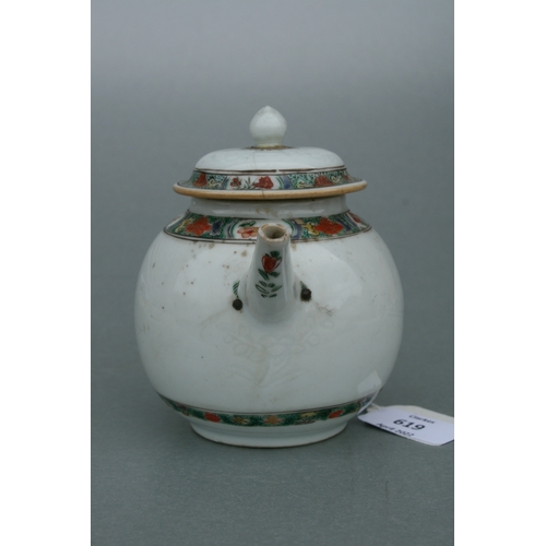 619 - A Chinese famille rose teapot of globular form, decorated with sgraffito and flowers, 11cms high.