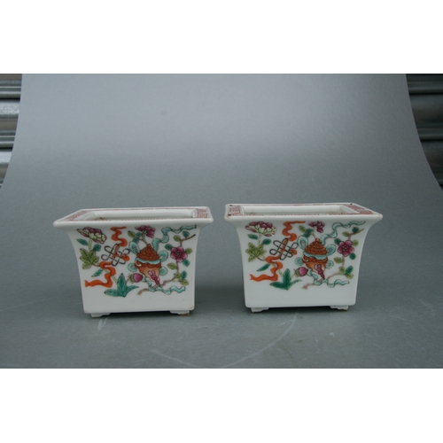 631 - A pair of rectangular form Chinese famille rose planters on stands decorated with precious objects, ... 