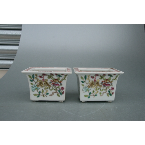 631 - A pair of rectangular form Chinese famille rose planters on stands decorated with precious objects, ... 