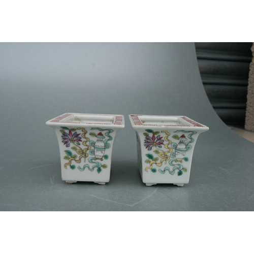 631 - A pair of rectangular form Chinese famille rose planters on stands decorated with precious objects, ... 