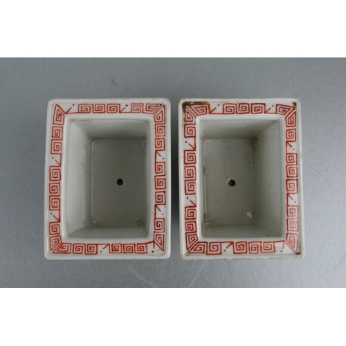 631 - A pair of rectangular form Chinese famille rose planters on stands decorated with precious objects, ... 