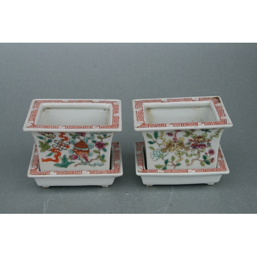 631 - A pair of rectangular form Chinese famille rose planters on stands decorated with precious objects, ... 