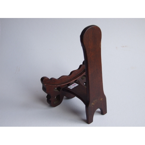 596 - Two Chinese hardwood plate stands, the largest 18cms high (2).