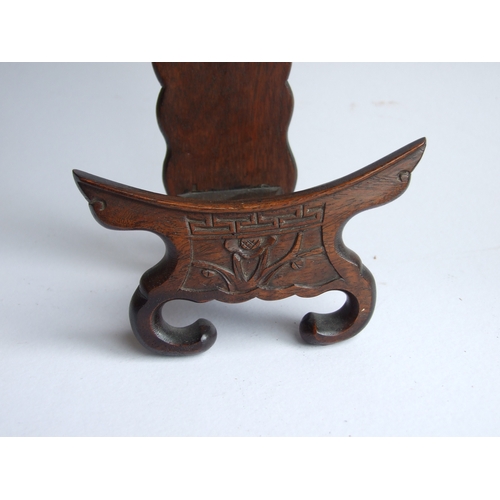 596 - Two Chinese hardwood plate stands, the largest 18cms high (2).