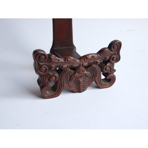 596 - Two Chinese hardwood plate stands, the largest 18cms high (2).