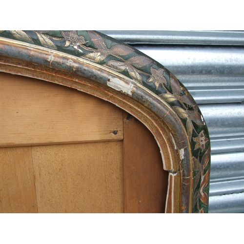 694 - A Victorian overmantle mirror frame with gilded and painted floral decoration, 104cms wide.