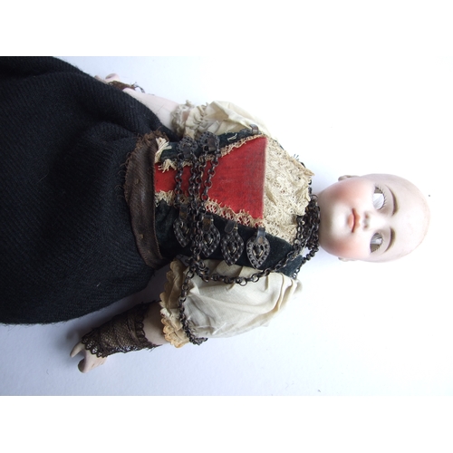 71 - A German bisque headed doll, 31cms high.