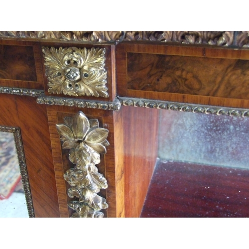 760 - A 19th century figured walnut Credenza, the pair of mirrored doors enclosing a shelved interior flan... 