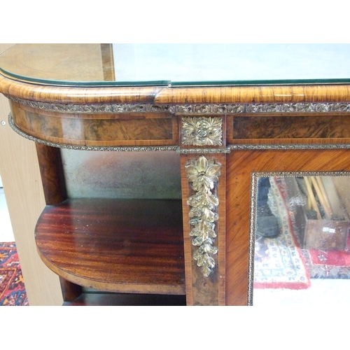 760 - A 19th century figured walnut Credenza, the pair of mirrored doors enclosing a shelved interior flan... 