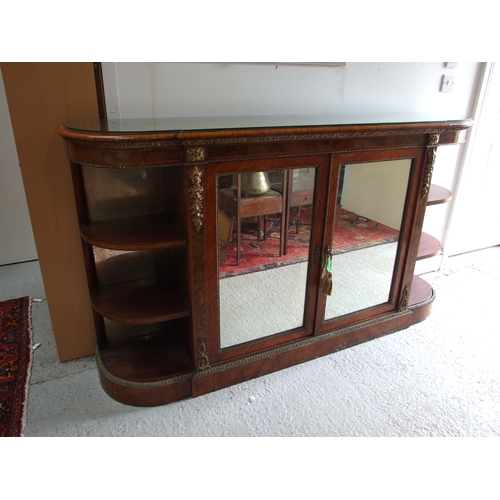 760 - A 19th century figured walnut Credenza, the pair of mirrored doors enclosing a shelved interior flan... 