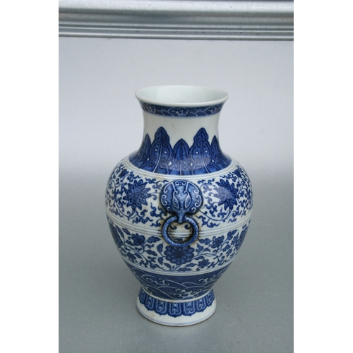 633 - A Chinese blue & white vase with elephant mask handles, decorated with foliate scrolls and waves, bl... 