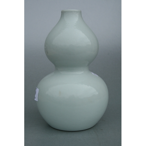 639 - A Chinese pale celadon glaze double gourd vase on stand, six character blue mark to the underside wi... 