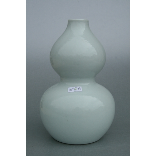 639 - A Chinese pale celadon glaze double gourd vase on stand, six character blue mark to the underside wi... 