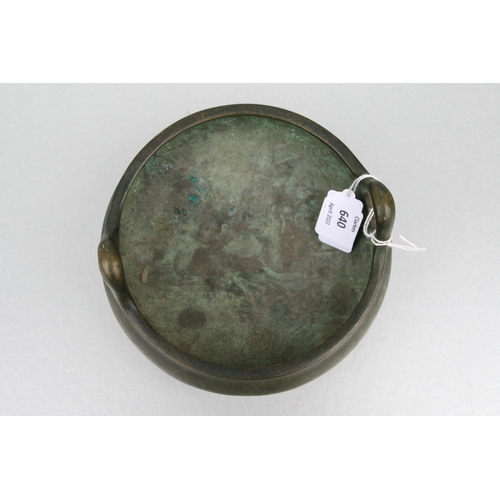 640 - A Chinese bronze two-handled censer on tripod legs, six character mark to the underside, 16cms diame... 