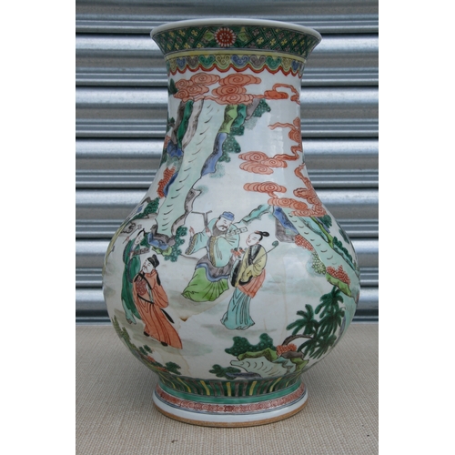 511 - A large Chinese famille rose vase decorated with figures in a landscape, 37cms high.