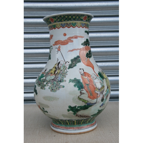 511 - A large Chinese famille rose vase decorated with figures in a landscape, 37cms high.