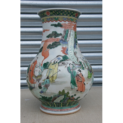 511 - A large Chinese famille rose vase decorated with figures in a landscape, 37cms high.