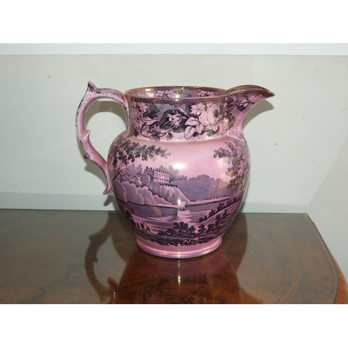 250 - A Victorian pink lustre ware jug, transfer printed with a landscape scene with a castle in the dista... 