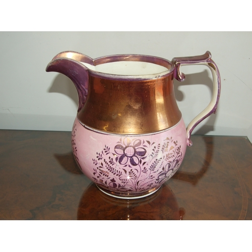 250 - A Victorian pink lustre ware jug, transfer printed with a landscape scene with a castle in the dista... 