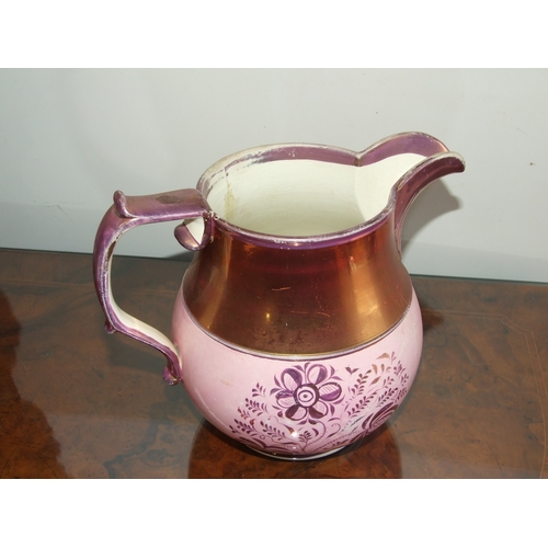 250 - A Victorian pink lustre ware jug, transfer printed with a landscape scene with a castle in the dista... 