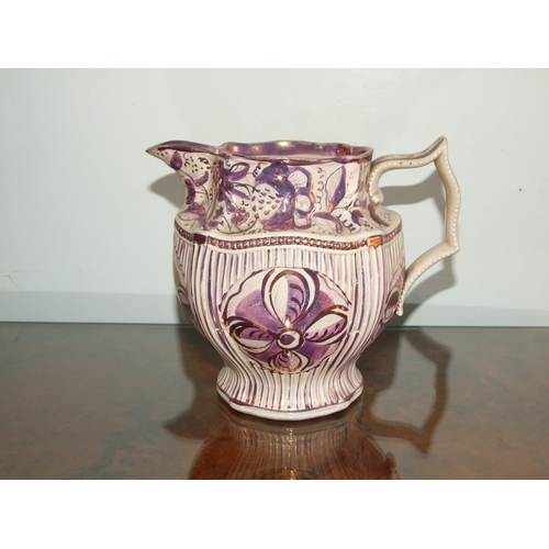 250 - A Victorian pink lustre ware jug, transfer printed with a landscape scene with a castle in the dista... 