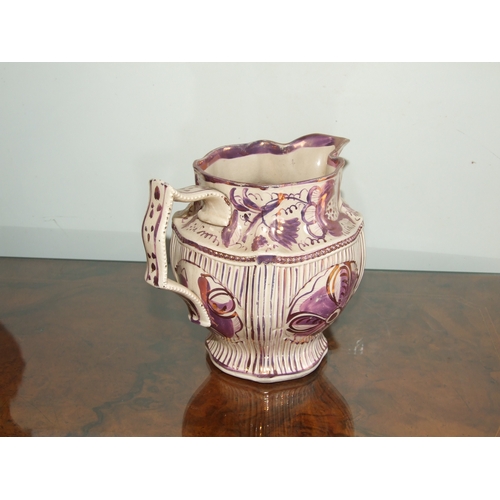 250 - A Victorian pink lustre ware jug, transfer printed with a landscape scene with a castle in the dista... 