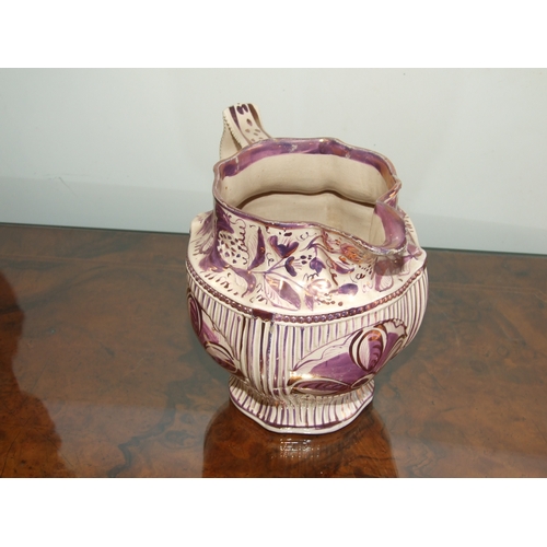 250 - A Victorian pink lustre ware jug, transfer printed with a landscape scene with a castle in the dista... 