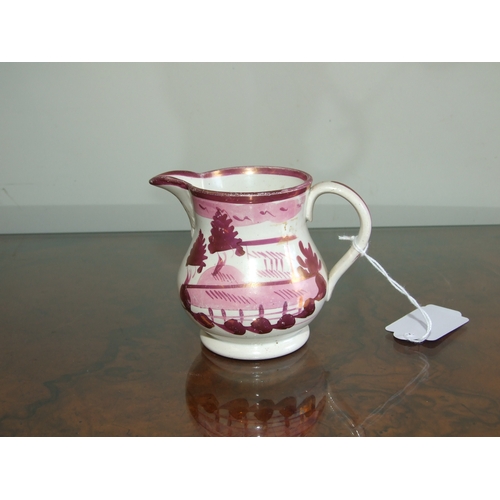 250 - A Victorian pink lustre ware jug, transfer printed with a landscape scene with a castle in the dista... 