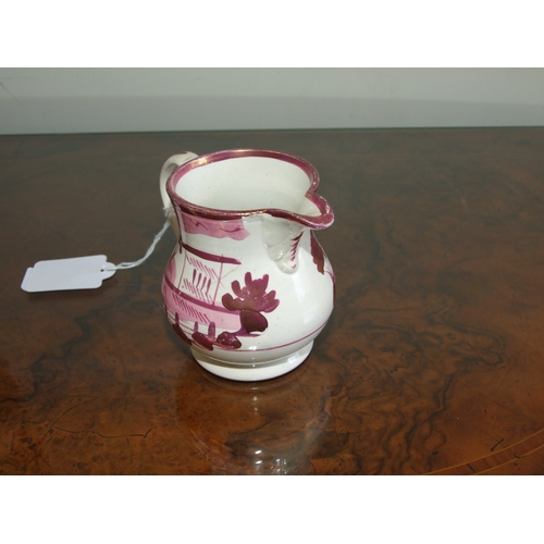 250 - A Victorian pink lustre ware jug, transfer printed with a landscape scene with a castle in the dista... 