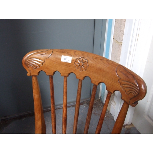 685 - Three elm and fruitwood kitchen chairs on turned legs joined by a stretcher (3).