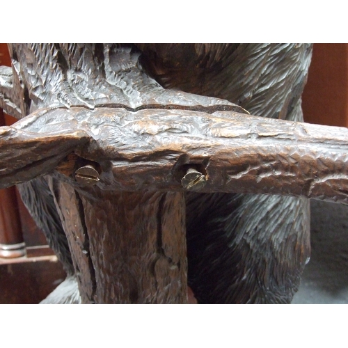 698 - A 20th century Black Forest carved bear hallstand, the adult bear climbing the tree and looking up a... 