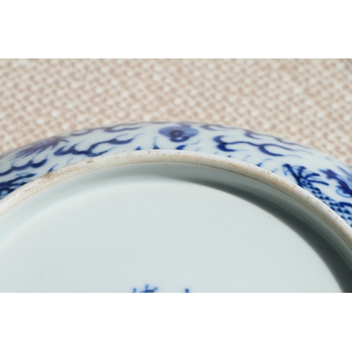 519 - A pair of Chinese blue & white shallow dishes decorated with dragons chasing a flaming pearl amongst... 