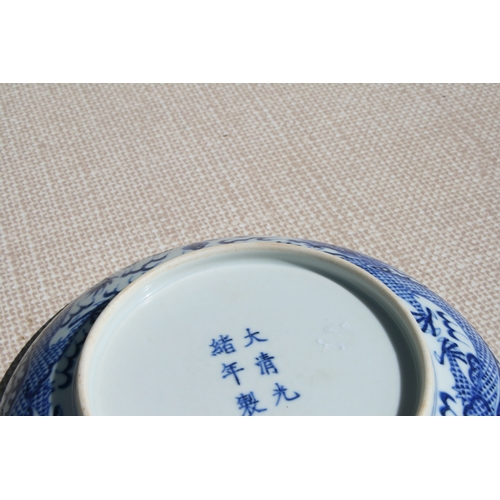 519 - A pair of Chinese blue & white shallow dishes decorated with dragons chasing a flaming pearl amongst... 