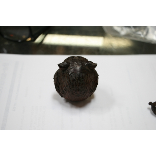 356 - An 18th century carved coquilla nut bodkin case (lacking cover) decorated with Cupid, 4cms high; tog... 