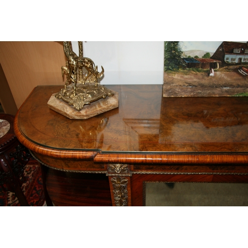 760 - A 19th century figured walnut Credenza, the pair of mirrored doors enclosing a shelved interior flan... 