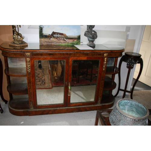 760 - A 19th century figured walnut Credenza, the pair of mirrored doors enclosing a shelved interior flan... 