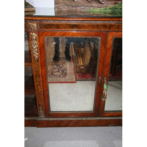 760 - A 19th century figured walnut Credenza, the pair of mirrored doors enclosing a shelved interior flan... 