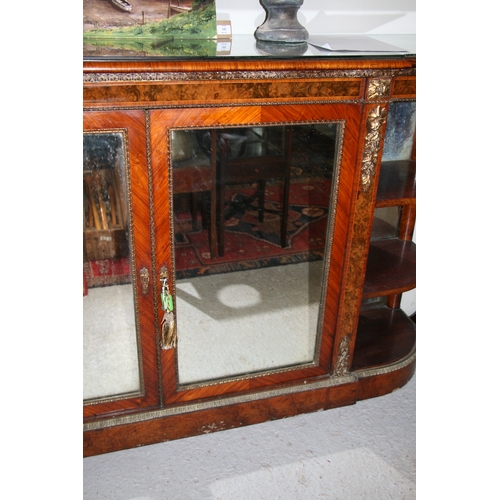 760 - A 19th century figured walnut Credenza, the pair of mirrored doors enclosing a shelved interior flan... 