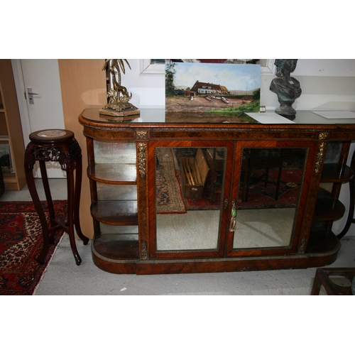 760 - A 19th century figured walnut Credenza, the pair of mirrored doors enclosing a shelved interior flan... 