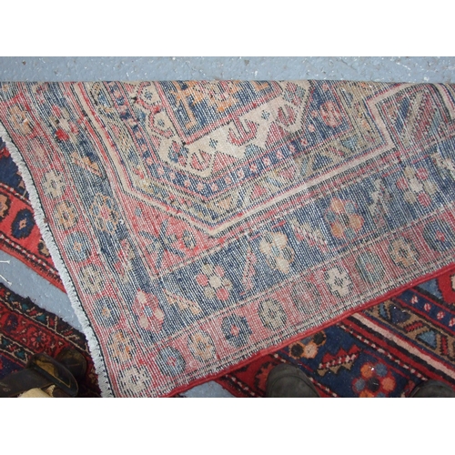 96 - A Persian Azari hand knotted woollen runner with five stylised guls within floral borders, on a blue... 