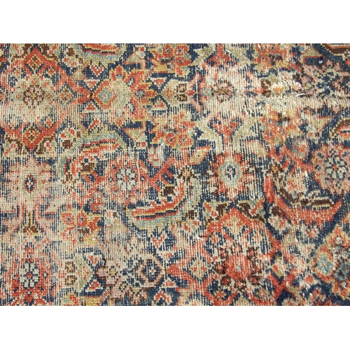 114 - A Persian Kellah runner with repeating geometric pattern on a red ground, 472 by 174cms.