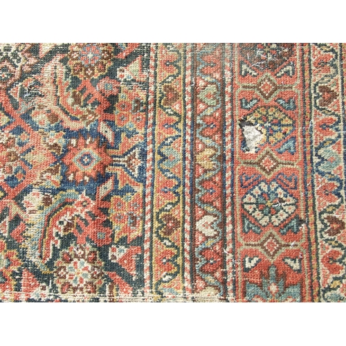 114 - A Persian Kellah runner with repeating geometric pattern on a red ground, 472 by 174cms.